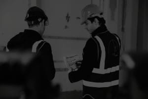 1.61 London studio process - project managers reviewing architectural plans on-site during a luxury property development.